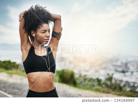 Fitness, woman and stretching arms for running outdoors with music for health, workout or cardio routine. Stretch, exercise and African female runner in nature with podcast for training motivation 134169997