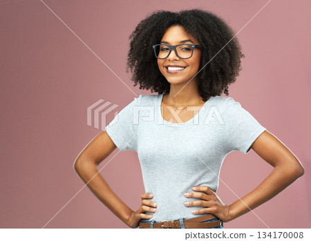 Portrait, smile and black woman with glasses akimbo in studio isolated on a pink background. Natural beauty, nerd and African female model from Nigeria with confidence, cosmetics and face mockup. Portrait, smile and black woman with glasses akimbo in studio isolated on a pink background. Natural beauty, nerd and African female model from Nigeria with confidence, cosmetics and face mockup. 134170008