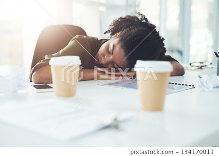 Tired, sleeping and business woman on desk with fatigue, stress and exhausted working in office. Burnout, overworked and lazy African female worker overwhelmed for deadline, workload and pressure 134170011