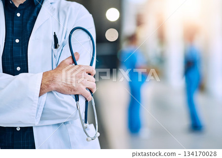 Medical, crossed arms and closeup of a doctor with a stethoscope in a hospital with mockup space. Career, professional and zoom of a male healthcare worker hand with equipment in a medicare clinic. 134170028