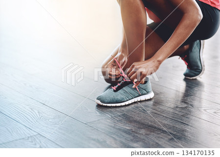 Sneakers, fitness and person tie laces to start exercise, workout or wellness sport in a gym for health performance. Shoes, space and hands of a healthy woman or runner ready for training or sports Sneakers, fitness and person tie laces to start exercise, workout or wellness sport in a gym for health performance. Shoes, space and hands of a healthy woman or runner ready for training or sports 134170135