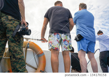 Back view of men discussing something on a boat Back view of men discussing something on a boat 134170158