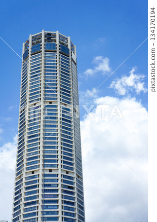 The exterior of a skyscraper towering under the blue sky The exterior of a skyscraper towering under the blue sky 134170194