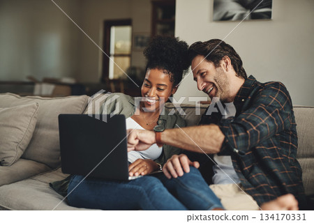 Laptop, interracial and entertainment with a couple watching a video using an online subscription service to relax. Computer, streaming or internet with a man and woman bonding together over a movie Laptop, interracial and entertainment with a couple watching a video using an online subscription service to relax. Computer, streaming or internet with a man and woman bonding together over a movie 134170331
