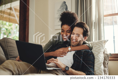 Laptop, streaming and an interracial couple watching a movie using an online subscription service for entertainment. Computer, relax or internet with a man and woman bonding together over a video Laptop, streaming and an interracial couple watching a movie using an online subscription service for entertainment. Computer, relax or internet with a man and woman bonding together over a video 134170333