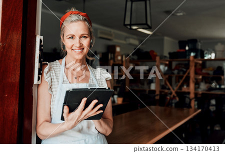 Happy woman, portrait smile and tablet in small business confidence at entrance for workshop in retail store. Confident female person, ceramic designer or owner with technology for creative startup Happy woman, portrait smile and tablet in small business confidence at entrance for workshop in retail store. Confident female person, ceramic designer or owner with technology for creative startup 134170413