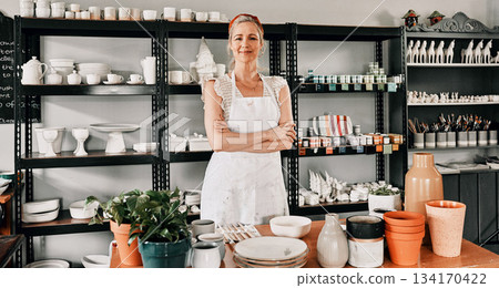 Happy woman, portrait and pottery with arms crossed in small business confidence for crafting in retail store. Confident female person, ceramic designer or owner smiling for craft or creative startup Happy woman, portrait and pottery with arms crossed in small business confidence for crafting in retail store. Confident female person, ceramic designer or owner smiling for craft or creative startup 134170422