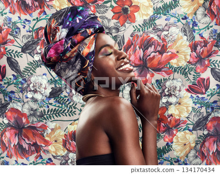 Flower pattern, head wrap and black woman with a smile, beauty and confident girl against a floral background. Female person, nature and model with a turn, fashion and stylish clothes with tradition Flower pattern, head wrap and black woman with a smile, beauty and confident girl against a floral background. Female person, nature and model with a turn, fashion and stylish clothes with tradition 134170434