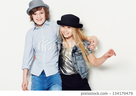 Fashion, kids or happy with a brother and sister in studio isolated on a white background for contemporary style. Smile, hat and children with best friends posing in fashionable or stylish clothes 134170479