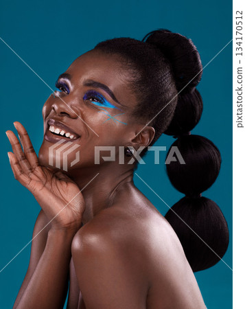Thinking, happy and makeup with a model black woman in studio on a blue background for hair or cosmetics. Face, idea and fashion with an attractive young female person posing for cosmetic beauty Thinking, happy and makeup with a model black woman in studio on a blue background for hair or cosmetics. Face, idea and fashion with an attractive young female person posing for cosmetic beauty 134170512