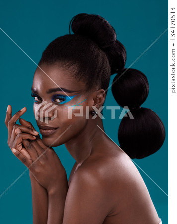 Portrait, beauty and cosmetics with a model black woman in studio on a blue background for hair or fashion. Face, makeup and haircare with an attractive young female person posing for haircare Portrait, beauty and cosmetics with a model black woman in studio on a blue background for hair or fashion. Face, makeup and haircare with an attractive young female person posing for haircare 134170513
