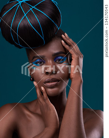 Portrait, hands and hair with a model black woman in studio on a blue background for beauty. Face, haircare and cosmetics with an attractive young female person touching her skin at the styling salon Portrait, hands and hair with a model black woman in studio on a blue background for beauty. Face, haircare and cosmetics with an attractive young female person touching her skin at the styling salon 134170543