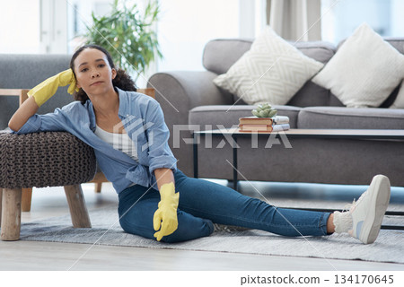Woman, portrait and cleaner relax after cleaning living room, housekeeping and tired housekeeper at home. Serious female person on break, clean house with hygiene and gloves for safety from bacteria Woman, portrait and cleaner relax after cleaning living room, housekeeping and tired housekeeper at home. Serious female person on break, clean house with hygiene and gloves for safety from bacteria 134170645