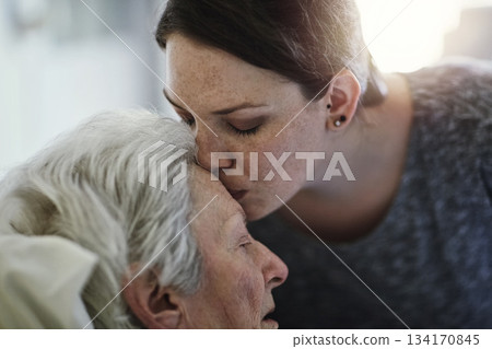 Senior, daughter and kiss mother in hospital for healthcare, visiting sick patient and resting. Clinic, woman and kissing elderly mom on forehead with love, care and empathy, kindness and comforting. Senior, daughter and kiss mother in hospital for healthcare, visiting sick patient and resting. Clinic, woman and kissing elderly mom on forehead with love, care and empathy, kindness and comforting. 134170845