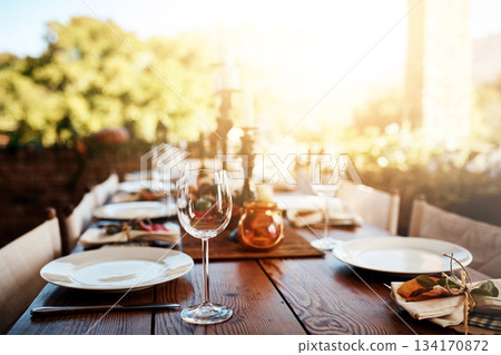 Thanksgiving, dinner table and decoration for a party, banquet or celebration in the backyard. Plate, wine glass and decor with a rustic elegant dining set, cutlery and tableware outside feast. 134170872