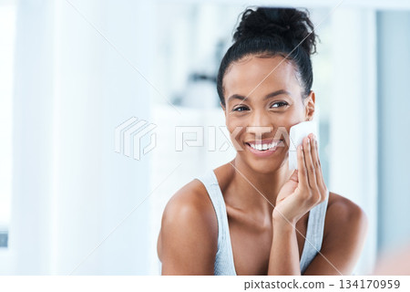 Skincare, black woman with cotton pad on face and smile, makeup cleaning and luxury skin product in bathroom. Dermatology, cosmetics and beauty facial, African model with cleansing pads and mock up. 134170959