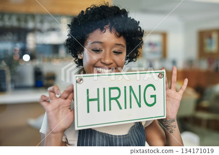 Happy woman, hiring sign and window at cafe in small business for growth, advertising or billboard. African female person at restaurant holding board for hire message or recruiting at coffee shop 134171019