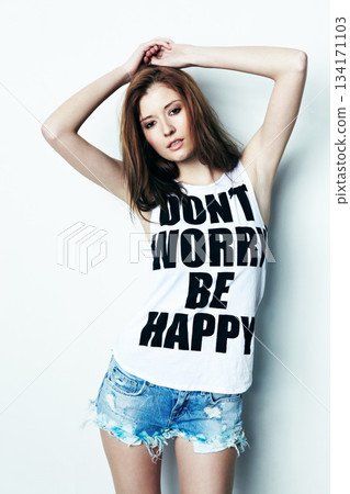 Portrait, young and a woman with a message on a shirt isolated on a white background in a studio. Fashion, stylish and a model with a tshirt and words of encouragement, empowerment and confidence Portrait, young and a woman with a message on a shirt isolated on a white background in a studio. Fashion, stylish and a model with a tshirt and words of encouragement, empowerment and confidence 134171103