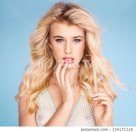 Portrait, fashion and hair with a woman in studio on a blue background for beauty or shampoo treatment. Face, shampoo or haircare with an attractive young female model posing for salon makeup Portrait, fashion and hair with a woman in studio on a blue background for beauty or shampoo treatment. Face, shampoo or haircare with an attractive young female model posing for salon makeup 134171128