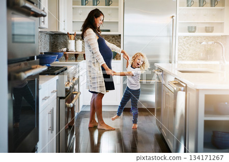 Happy family, pregnant woman with boy child and in kitchen at their home with lens flare. Mother with love or care, mother and cheerful parent with son bonding with dance in their house together 134171267
