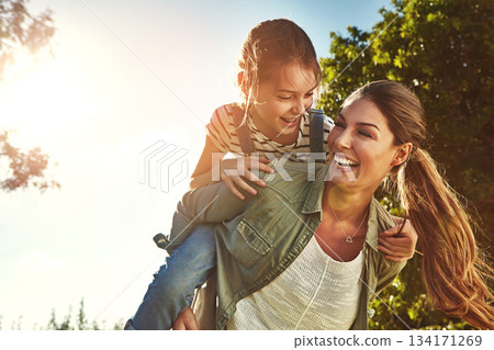 Piggyback, happy and a mother and child in nature for bonding, happiness and love in summer. Laughing, relax and a mom and a girl kid in a park or garden for playing together and quality time Piggyback, happy and a mother and child in nature for bonding, happiness and love in summer. Laughing, relax and a mom and a girl kid in a park or garden for playing together and quality time 134171269