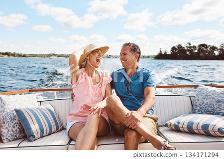 Laughing, happy couple and on a boat for retirement travel, summer freedom and holiday in Bali. Smile, love and a senior man and woman on a yacht for vacation adventure, luxury and a cruise date 134171294
