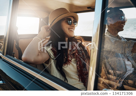 Happy couple, summer and on a road trip in a car for freedom, travel and holiday. Smile, relax and a young man and woman in transportation driving for a vacation, date or an adventure together 134171306