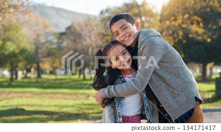 Park, hug and portrait of brother and sister enjoying summer day for bonding, quality time and playing. Family, children and happy siblings hugging, embrace and loving in nature for relaxing together 134171417