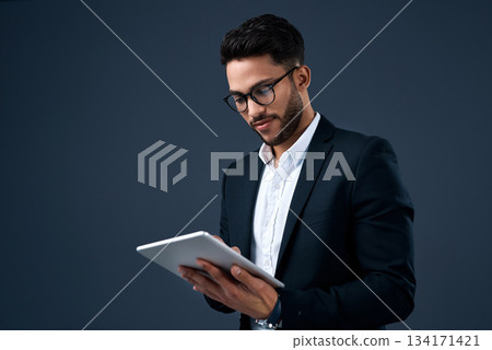 Technology, professional young businessman with tablet and in a studio background. Social networking or digital communication, isolated and male person with mobile device search on backdrop. Technology, professional young businessman with tablet and in a studio background. Social networking or digital communication, isolated and male person with mobile device search on backdrop. 134171421
