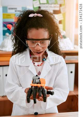 Excited, education and girl with a robot, science class and innovation with progress, creativity and development. Female child, girl and student with technology, robotics and learning with excitement Excited, education and girl with a robot, science class and innovation with progress, creativity and development. Female child, girl and student with technology, robotics and learning with excitement 134171428