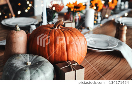 Thanksgiving, pumpkin and holiday celebration or table in a empty home dining room with decoration. Season, art and creative background with orange vegetable, place setting and rustic inspiration Thanksgiving, pumpkin and holiday celebration or table in a empty home dining room with decoration. Season, art and creative background with orange vegetable, place setting and rustic inspiration 134171434
