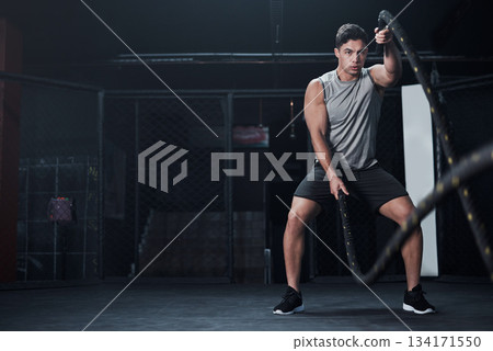 Fitness, battle ropes and man at the gym doing strength, cardio and challenge workout. Strong, energy and male athlete doing exercise or training with equipment for health and wellness in sports club Fitness, battle ropes and man at the gym doing strength, cardio and challenge workout. Strong, energy and male athlete doing exercise or training with equipment for health and wellness in sports club 134171550