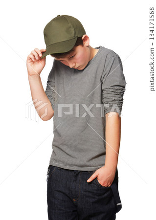 Fashion, cool and a shy teenager with a cap isolated on a white background in a studio. Serious, thinking and a young boy looking awkward, introverted and with shame while stylish in clothes Fashion, cool and a shy teenager with a cap isolated on a white background in a studio. Serious, thinking and a young boy looking awkward, introverted and with shame while stylish in clothes 134171568