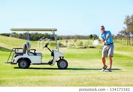 Sports, relax and swing with man on golf course with cart for hobby, training and competition. Game, action and fitness with male golfer and stroke on grass field for golfing, summer and recreation 134171582