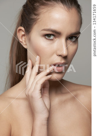 Skincare, beauty and portrait of woman in studio for wellness, facial treatment and self care. Dermatology, spa and face of female person with natural cosmetics, makeup and glow on gray background 134171659