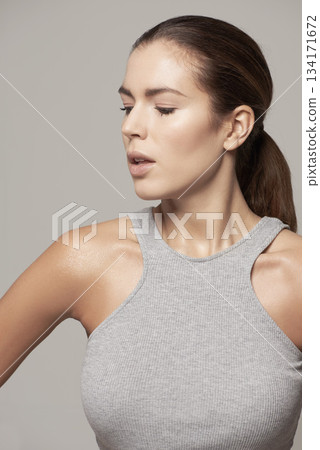 Beauty, close up and style or young woman in natural facial cosmetics and against a grey background. Makeup, glow and beautiful woman model or healthy skin or clean face and fashion in studio Beauty, close up and style or young woman in natural facial cosmetics and against a grey background. Makeup, glow and beautiful woman model or healthy skin or clean face and fashion in studio 134171672