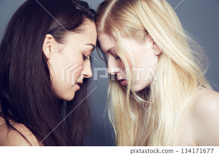 Face, skin and beauty of women couple in studio for makeup, cosmetics and lgbtq love. Headshot of gay or lesbian people together on a grey background for hair color, skincare and natural glow 134171677