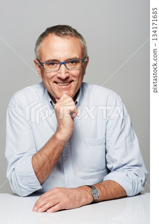Portrait, business and mature man with a smile, confident and manager against a studio background. Face, happy male person and employee with happiness, skills and professional with career and success Portrait, business and mature man with a smile, confident and manager against a studio background. Face, happy male person and employee with happiness, skills and professional with career and success 134171685