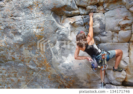 Rock climbing, fitness and challenge with woman on mountain for adventure and travel with space. Strong, freedom and hiking with female climber training in nature for courage, safety and workout Rock climbing, fitness and challenge with woman on mountain for adventure and travel with space. Strong, freedom and hiking with female climber training in nature for courage, safety and workout 134171746