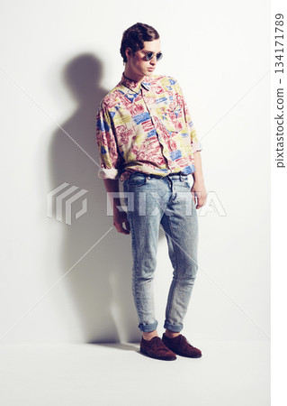 Fashion, unique and funky with a hipster man in studio on a white background for contemporary style. Trendy, cool and edgy with a handsome young male model posing in stylish or fashionable clothes Fashion, unique and funky with a hipster man in studio on a white background for contemporary style. Trendy, cool and edgy with a handsome young male model posing in stylish or fashionable clothes 134171789