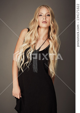 Fashion, beauty and portrait of a woman with makeup, cosmetics and long hair in studio. Young female aesthetic model with a skincare glow, designer style and seductive pose on a grey background Fashion, beauty and portrait of a woman with makeup, cosmetics and long hair in studio. Young female aesthetic model with a skincare glow, designer style and seductive pose on a grey background 134171822