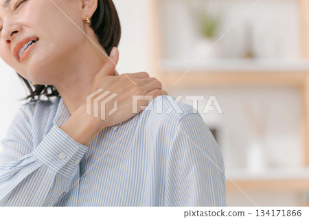 A woman suffering from stiff shoulders A woman suffering from stiff shoulders 134171866