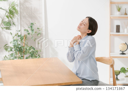 A woman suffering from stiff shoulders A woman suffering from stiff shoulders 134171867