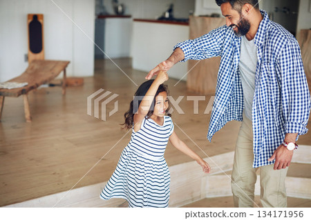 Family, father and girl dance, home and happiness with love, bonding and movement in the lounge. Male parent, female child and daughter with dad, kid and dancing for fun, playful and loving together 134171956