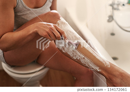 Health, bathroom and woman shaving her legs with a shaver and cream for a epilation routine. Wellness, hair removal and closeup of a female person doing a depilation shave treatment at her home. Health, bathroom and woman shaving her legs with a shaver and cream for a epilation routine. Wellness, hair removal and closeup of a female person doing a depilation shave treatment at her home. 134172061