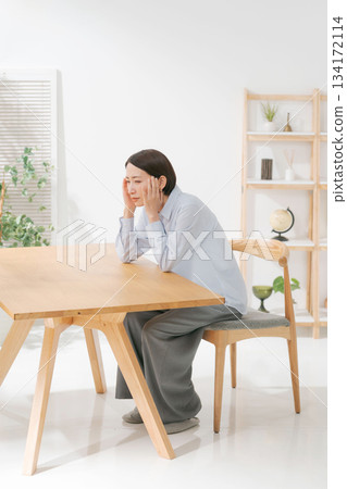 A woman suffering from a headache 134172114