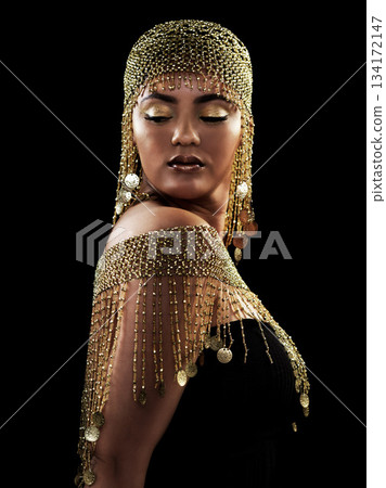 Woman, beauty and queen in studio with gold, jewelry and elegance on black background. Golden, makeup and female model pose in luxury, rich and fancy accessories with ethereal fantasy aesthetic 134172147