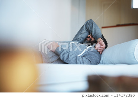 Tired, insomnia and a man with stress on a bed with burnout, sad and mental health problem. Fatigue, depression and a person sleeping in the bedroom of a house while depressed or sick with a hangover Tired, insomnia and a man with stress on a bed with burnout, sad and mental health problem. Fatigue, depression and a person sleeping in the bedroom of a house while depressed or sick with a hangover 134172380