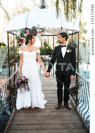 Love, wedding and couple holding hands, outdoor and relationship with joy, happiness and romantic. Partners, bride and groom with support, loving or marriage with romance, celebration and commitment Love, wedding and couple holding hands, outdoor and relationship with joy, happiness and romantic. Partners, bride and groom with support, loving or marriage with romance, celebration and commitment 134172449