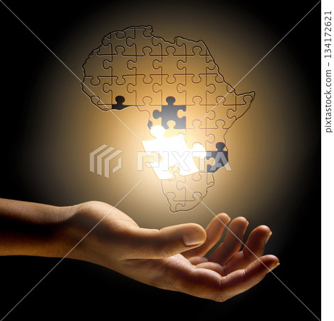 Closeup, Africa and hand with a puzzle, development and problem solving for growth, future and planning. Zoom, fingers or person with symbol, solidarity and support for global innovation and solution Closeup, Africa and hand with a puzzle, development and problem solving for growth, future and planning. Zoom, fingers or person with symbol, solidarity and support for global innovation and solution 134172621